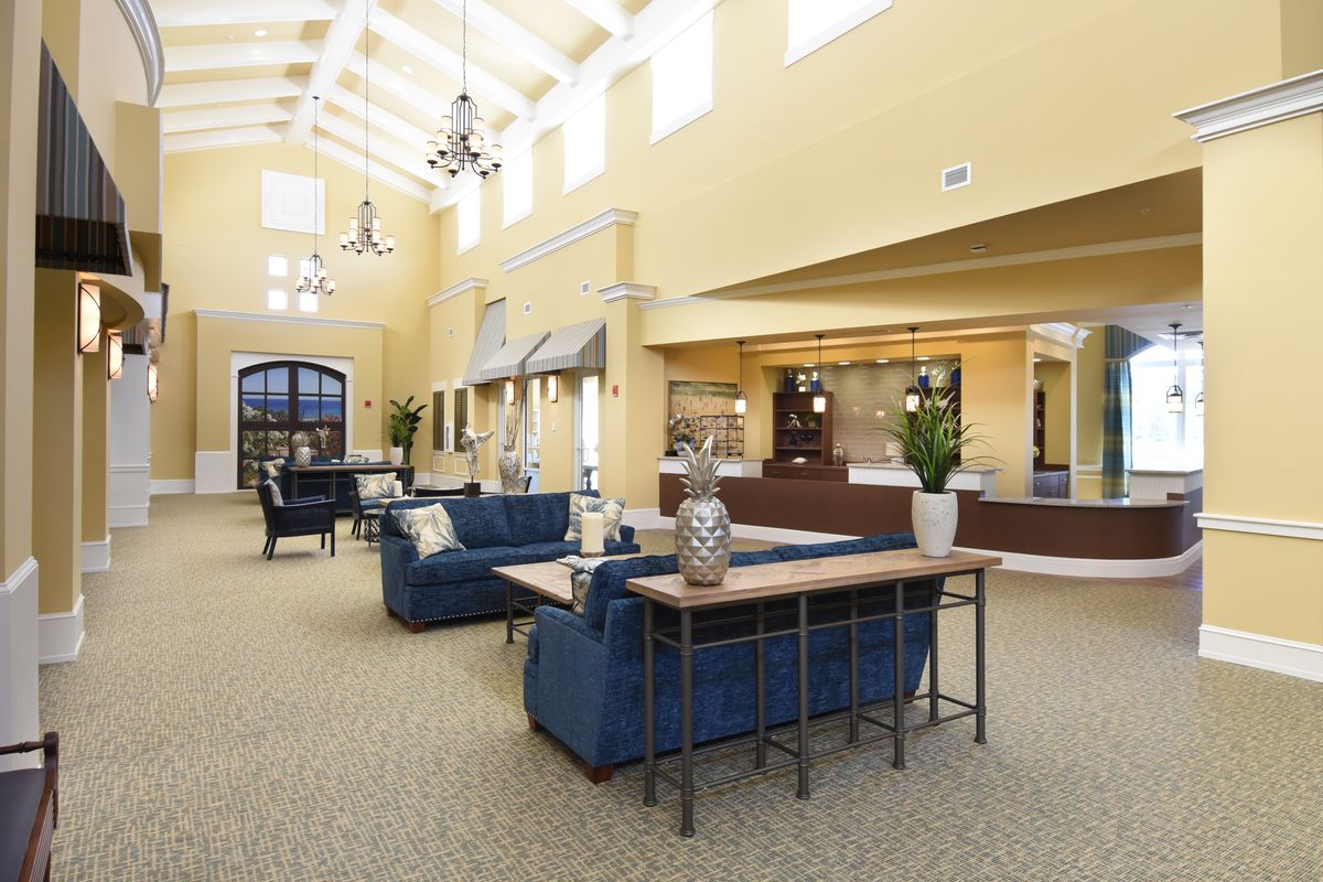 A spacious and well-lit lobby with comfortable seating and a reception desk.