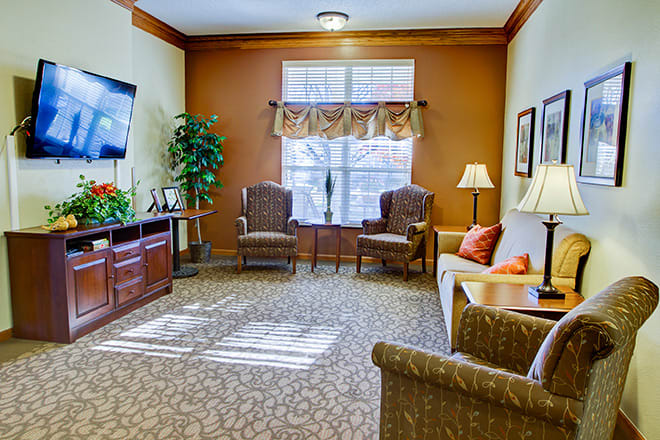 A cozy living room with comfortable seating, a television, and warm decor.