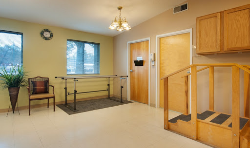 A spacious rehabilitation room featuring therapy equipment and accessible design.