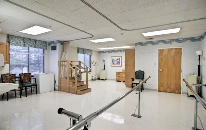A rehabilitation room equipped with parallel bars for physical therapy exercises.