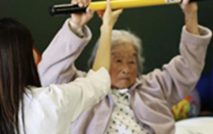 An elderly person participating in a physical therapy session.