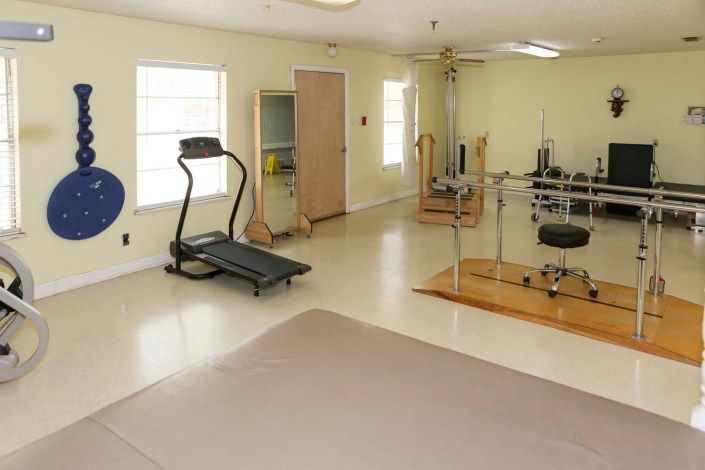 A home gym featuring a treadmill and various exercise equipment.