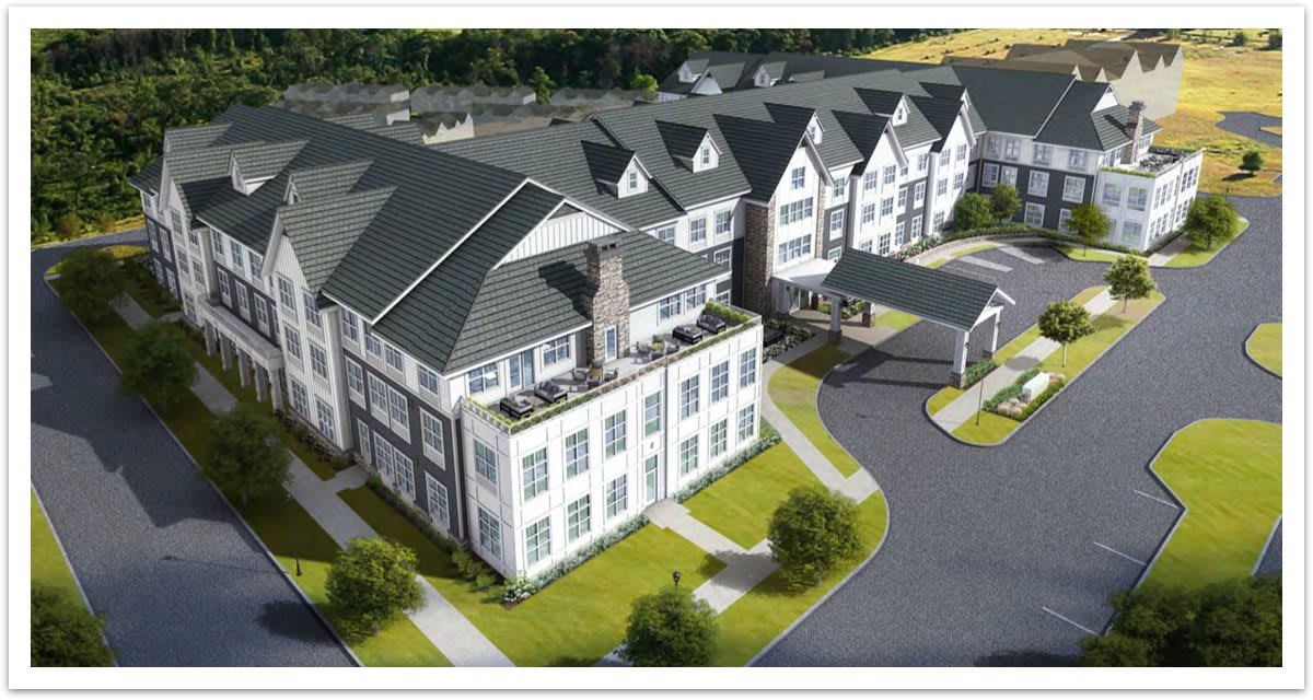 Aerial view of a modern residential housing complex with neatly landscaped surroundings.