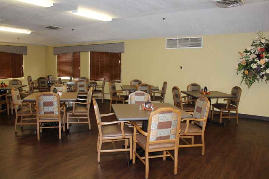 An empty dining room with arranged tables and chairs.