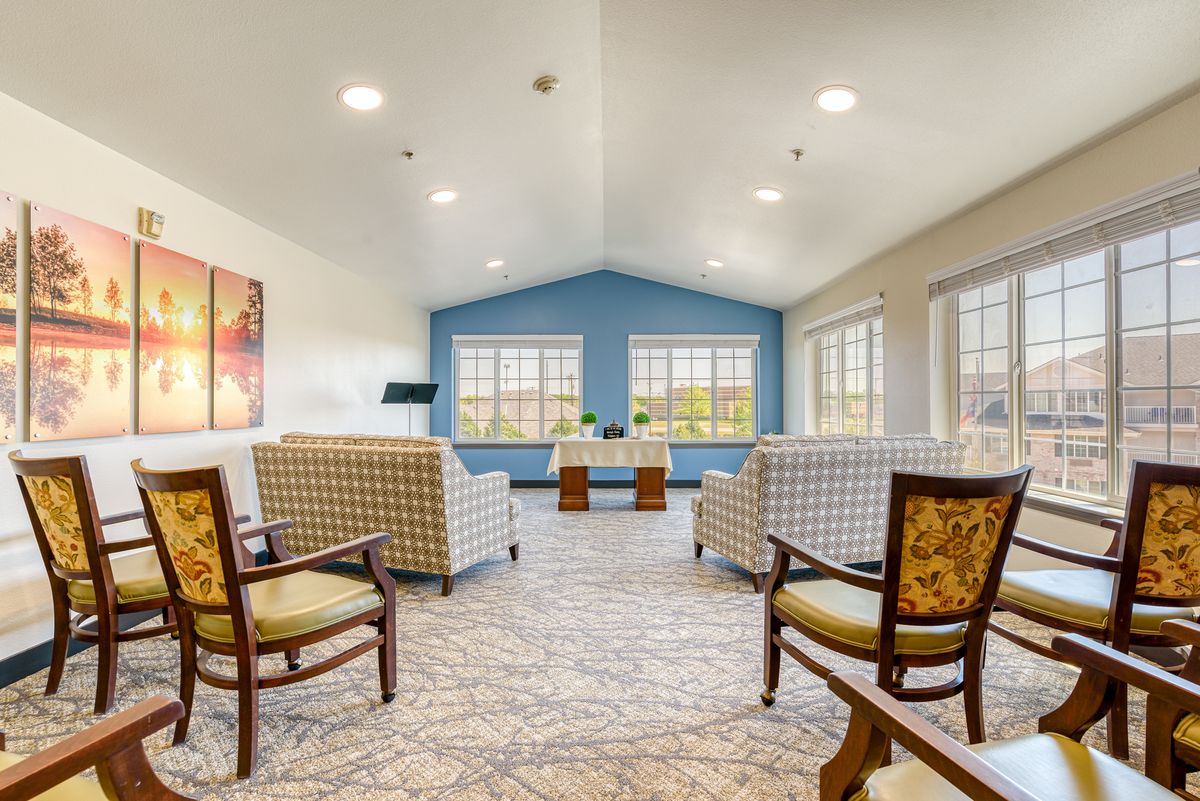 A bright and spacious living area with comfortable seating and large windows.