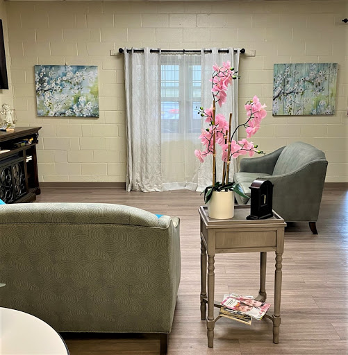 A cozy living room featuring comfortable seating and decorative elements.