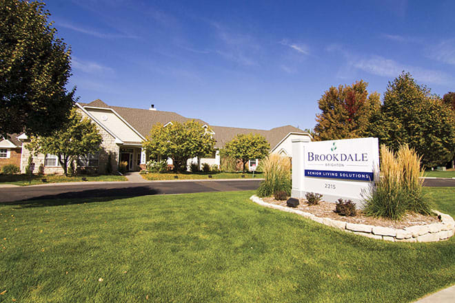 A well-maintained building with a landscaped lawn and prominent signage.