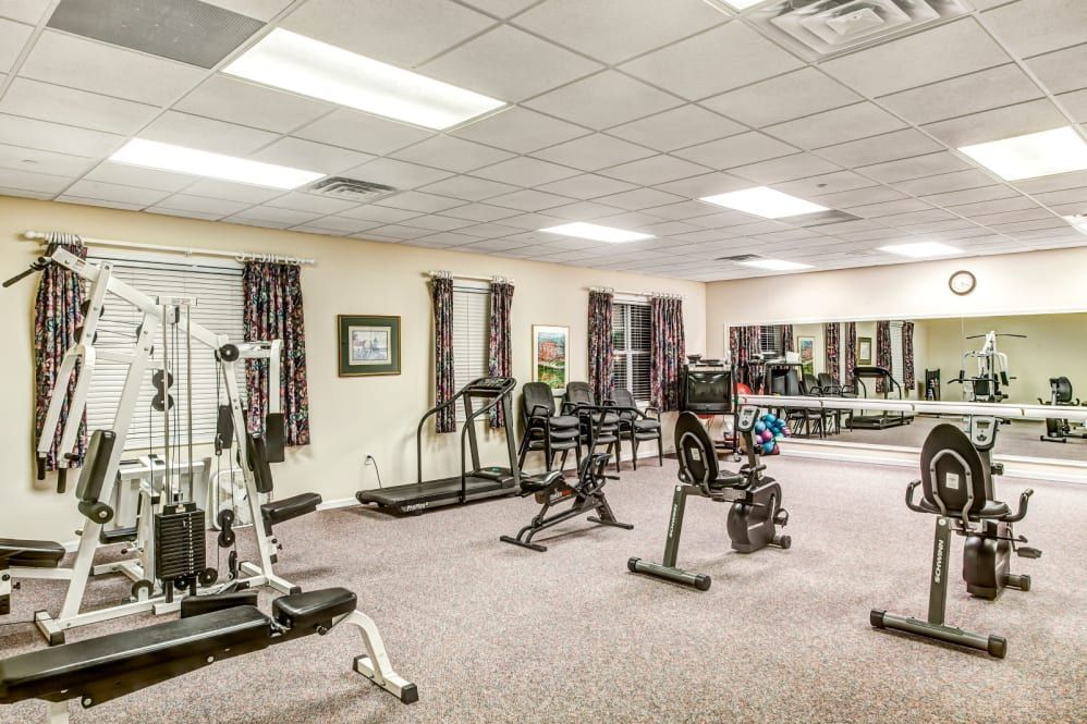 A fitness room equipped with various exercise machines and workout equipment.