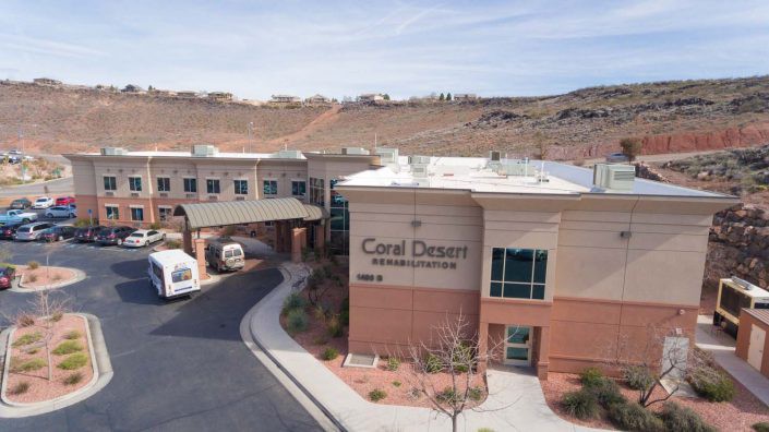 A medical facility building situated in a desert landscape.