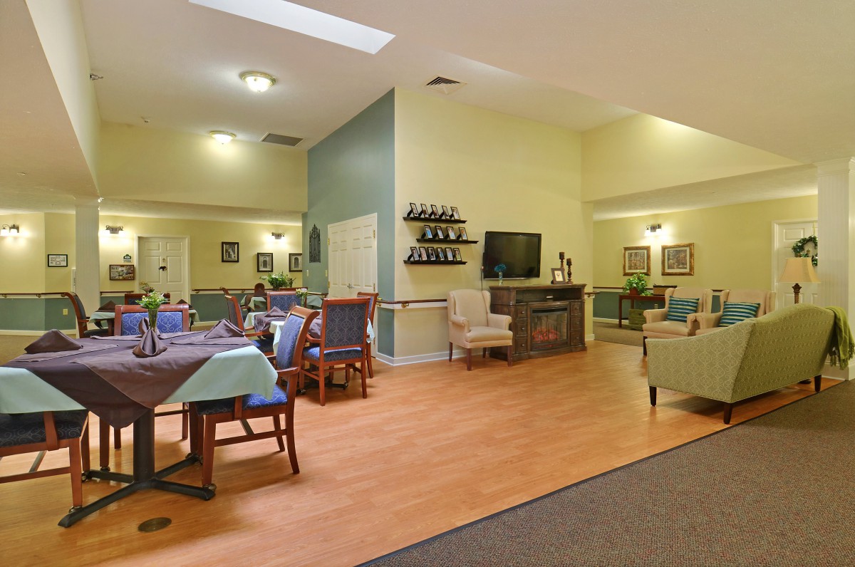 A spacious living and dining area with comfortable seating and a television.