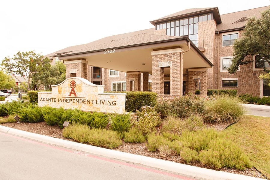 The entrance to a senior independent living facility with well-maintained landscaping.