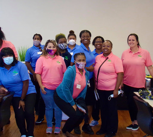A cheerful team gathered for a community service event, showcasing their unity and dedication.
