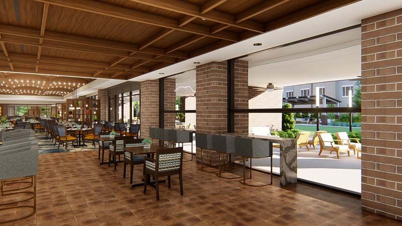 A modern cafe interior with brick walls, wooden ceilings, and ample natural light.