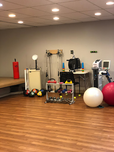 A well-equipped fitness and rehabilitation space featuring various exercise tools.
