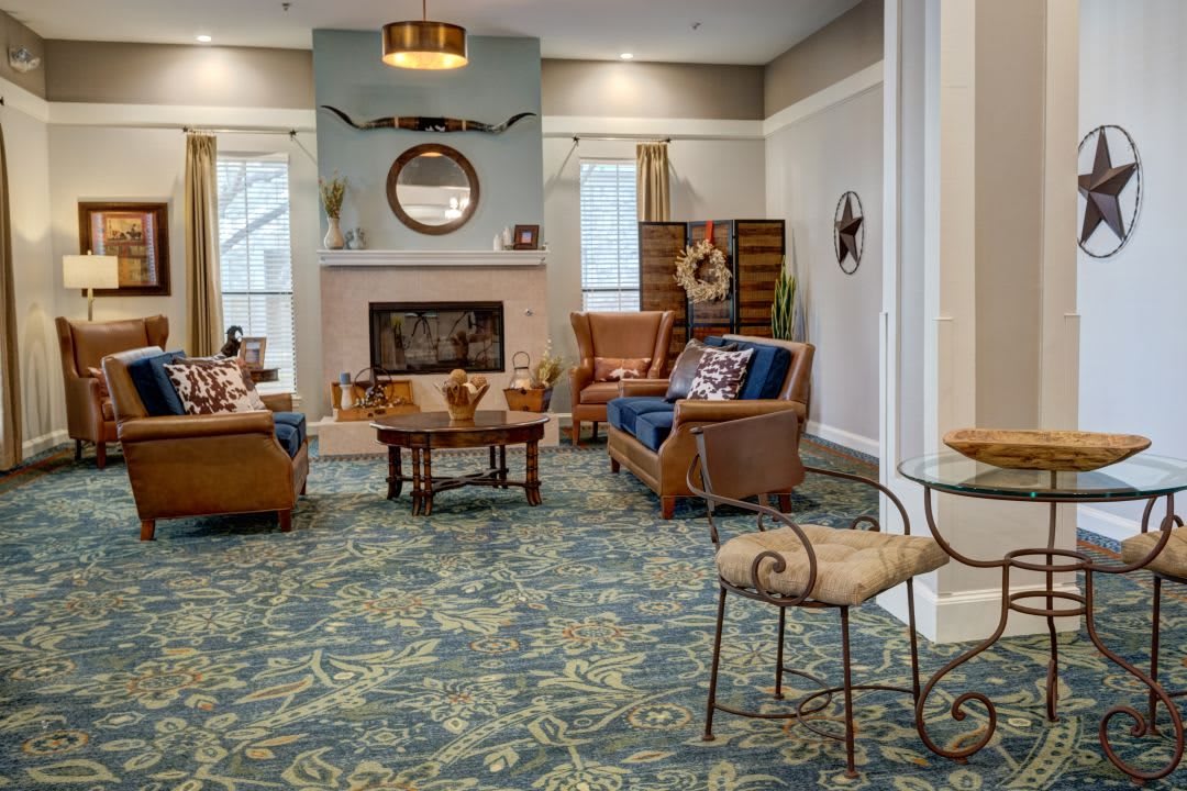 A cozy living room featuring a fireplace, comfortable seating, and elegant decor.