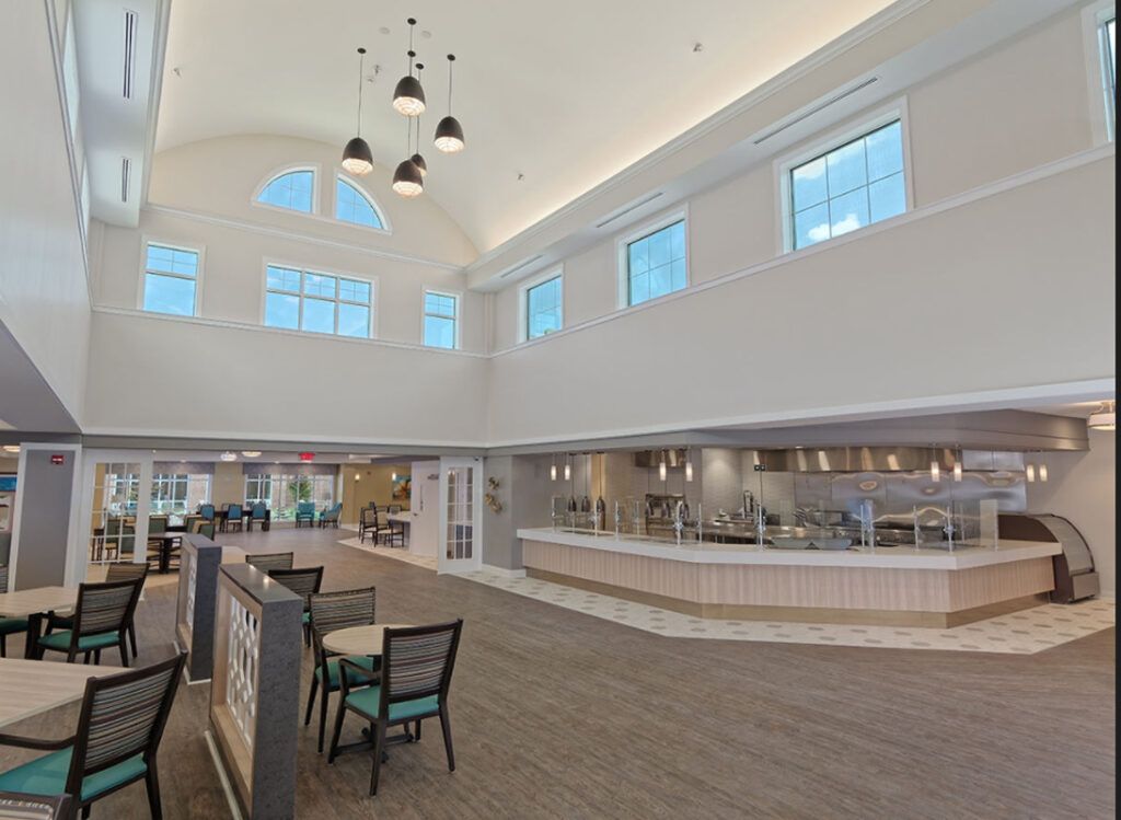 A spacious and modern cafe interior with ample natural light and a sleek design.