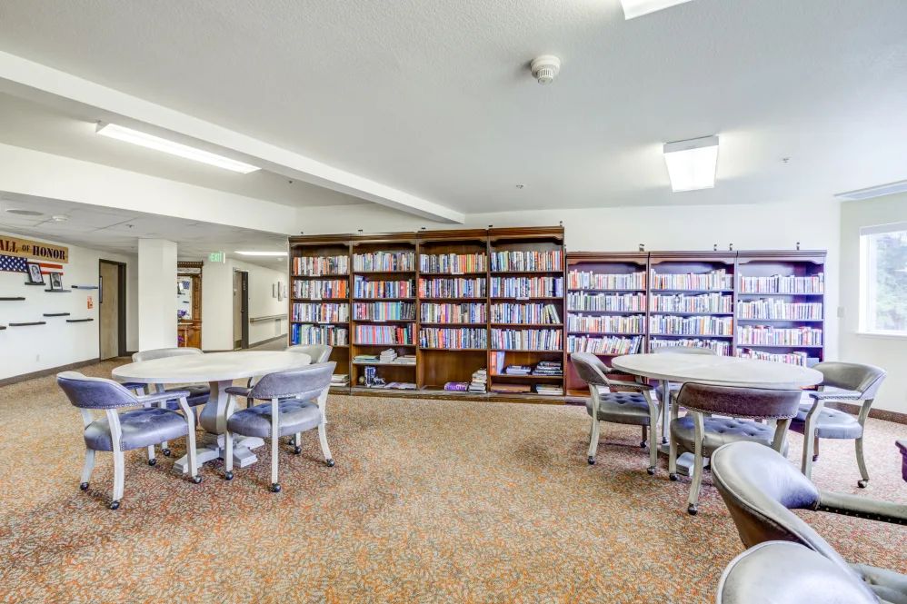 A quiet library with bookshelves and seating areas.