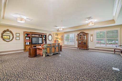 A spacious and inviting living room featuring elegant furniture and warm lighting.