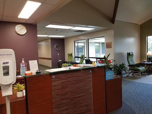 A welcoming reception area featuring modern furnishings and greenery.