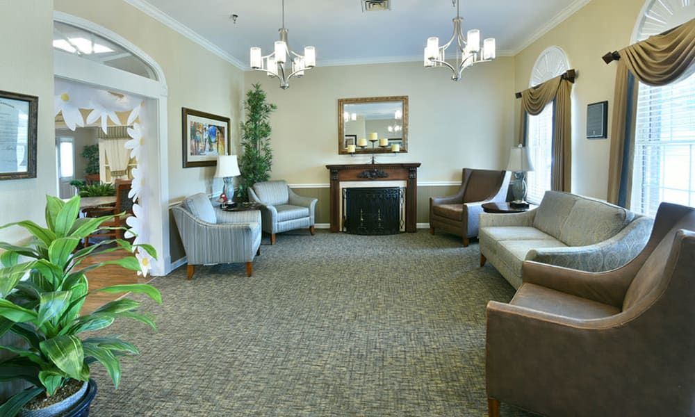 A cozy living room with comfortable seating, a fireplace, and elegant decor.