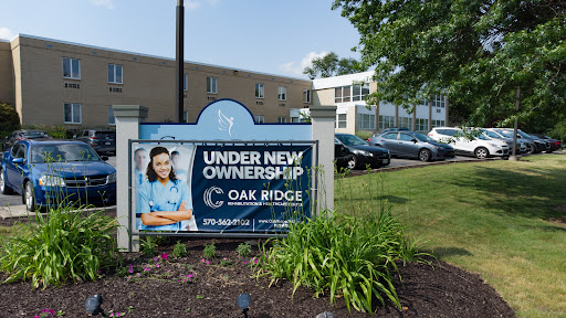 A sign indicating that Oak Ridge is under new ownership, displayed in front of the facility.