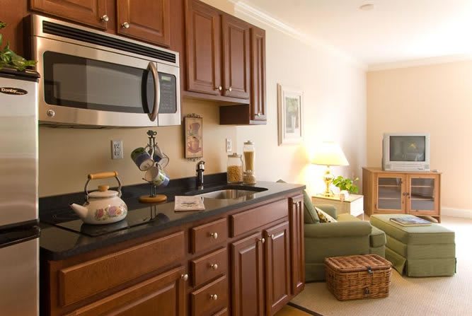 A cozy kitchen and living area with wood cabinets and modern amenities.