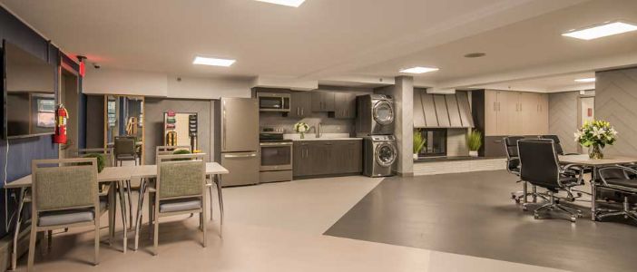 A modern open-plan kitchen with integrated laundry facilities.