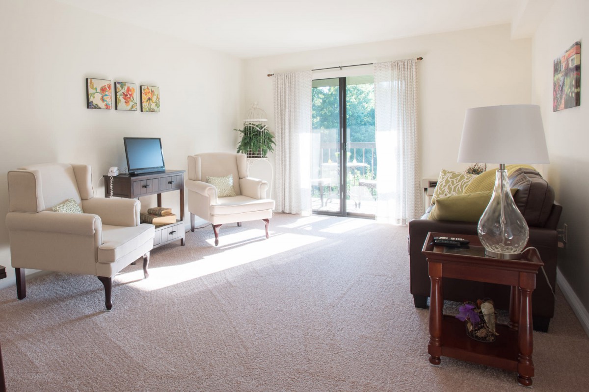 A bright and cozy living room with ample natural light and comfortable furniture.