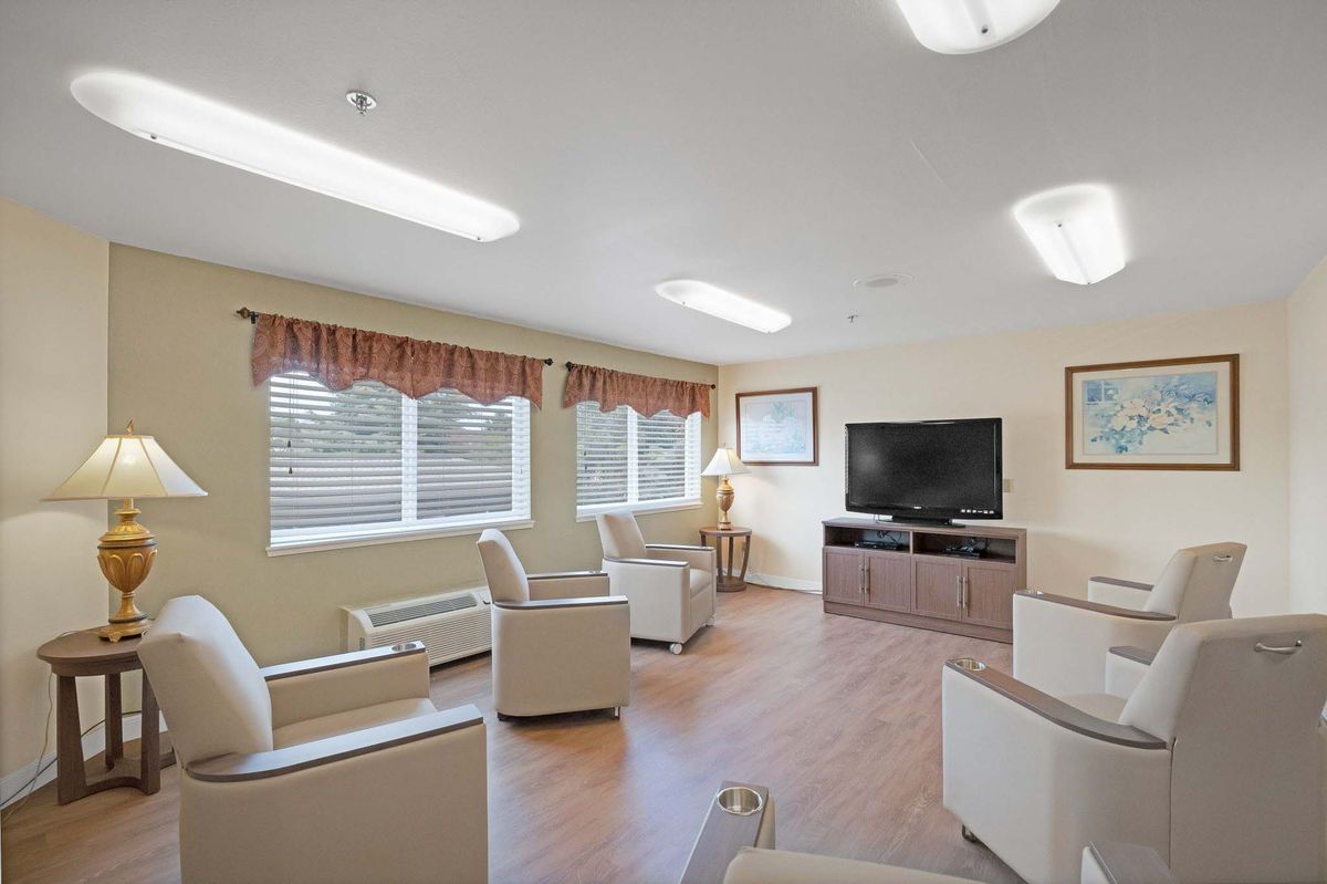 A cozy living room with comfortable seating and a TV for entertainment.