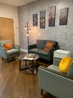 A cozy living room with modern furniture and warm decor.