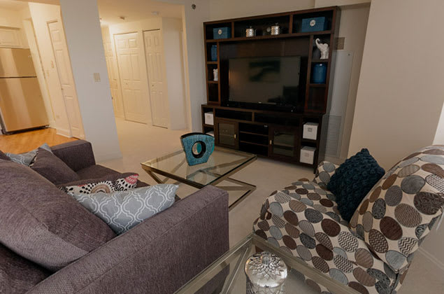 A cozy living room with a modern entertainment center and comfortable seating.