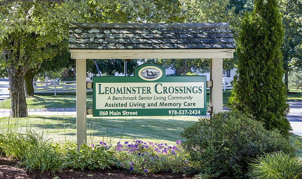 Sign for Leominster Crossings, a residential senior living community offering assisted living and memory care.