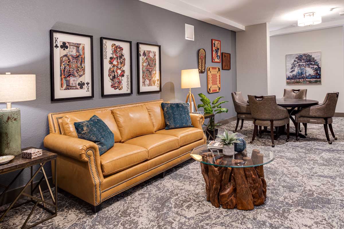 A stylish living room featuring a leather sofa, wooden coffee table, and modern wall art.
