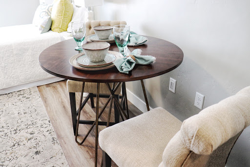 A beautifully set round dining table, perfect for a cozy meal with friends or family.
