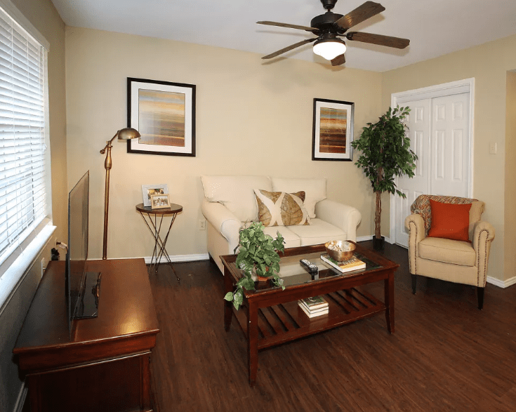 A cozy living room with a modern design featuring a comfortable sofa, coffee table, and tasteful decor.