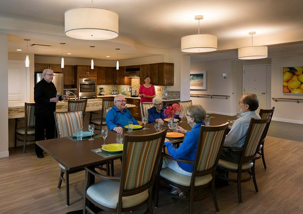 A group of people enjoying a meal together in a dining room setting.