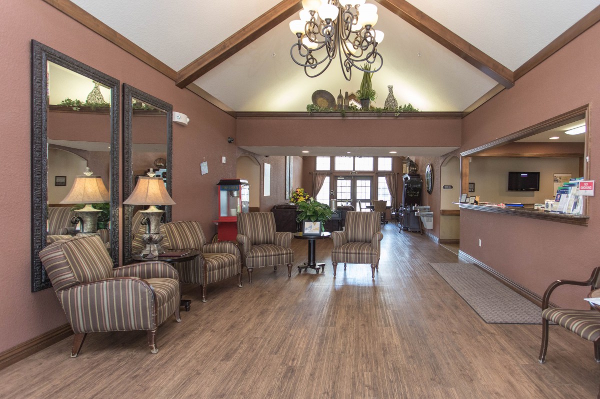 A cozy lobby with stylish furniture and a chandelier.