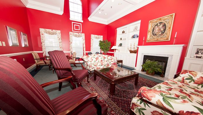 A traditional living room with red walls and classic furniture.