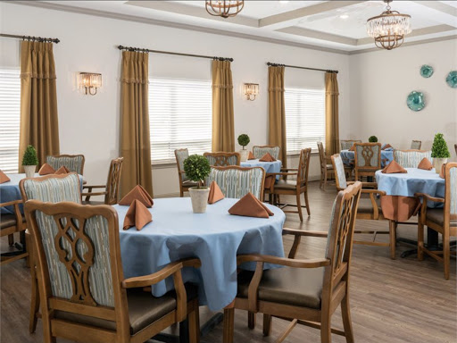 A beautifully arranged dining room featuring elegant furniture and warm lighting.