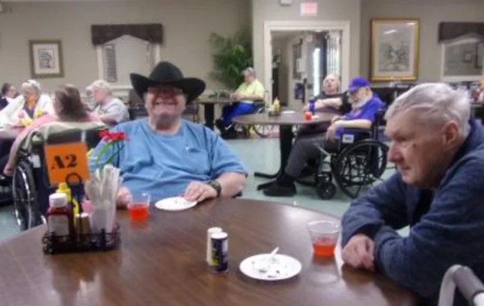 A group of seniors enjoying a gathering in a community room.