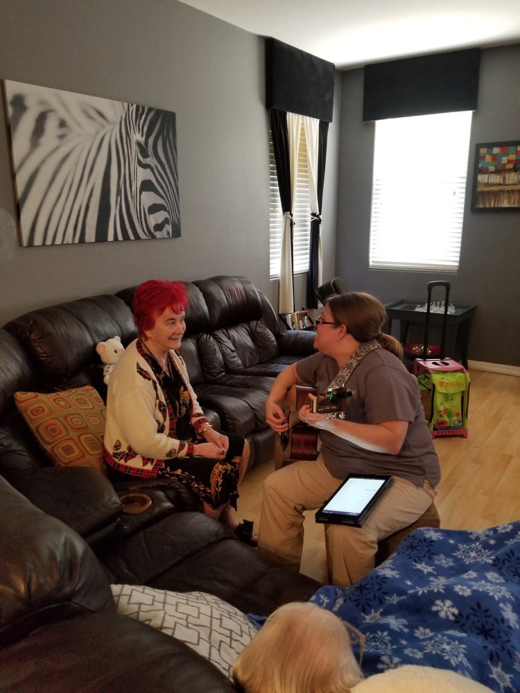 Two people enjoying a music session in the living room.