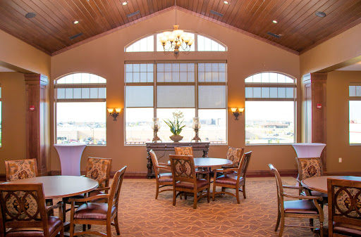 A well-lit dining area featuring elegant furnishings and large windows.
