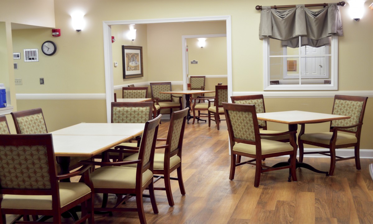 A cozy dining area with several tables and chairs arranged neatly.