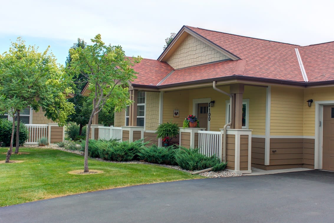 A charming single-story house with a welcoming front porch and well-maintained garden.