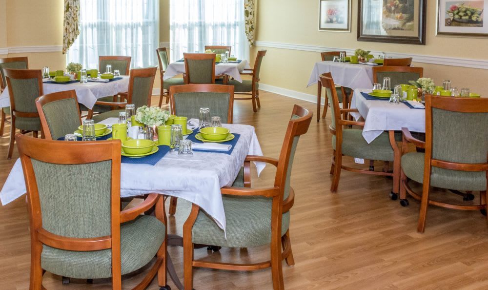 A well-decorated dining room with neatly arranged tables and chairs.