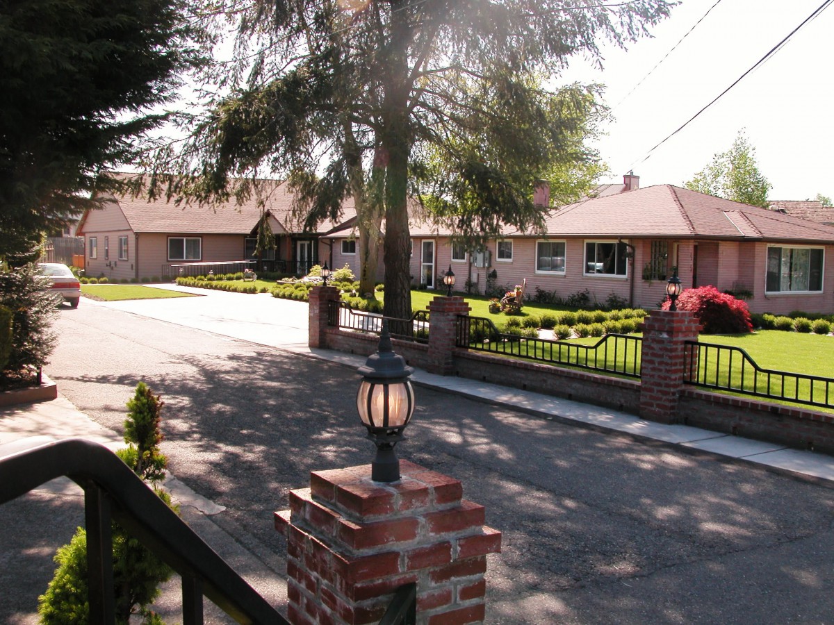 A quiet suburban neighborhood with well-maintained houses and landscaped yards.