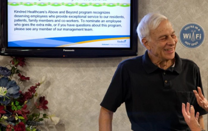 A man stands in front of a screen giving a presentation.