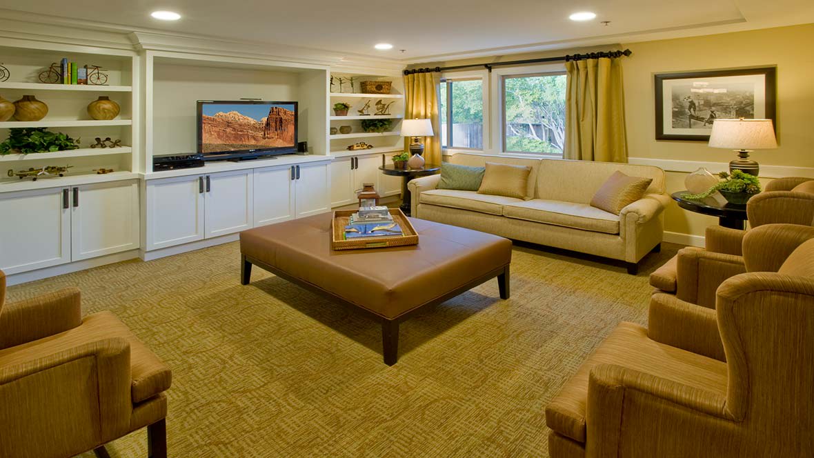 A cozy living room with a comfortable sofa, large coffee table, and television.