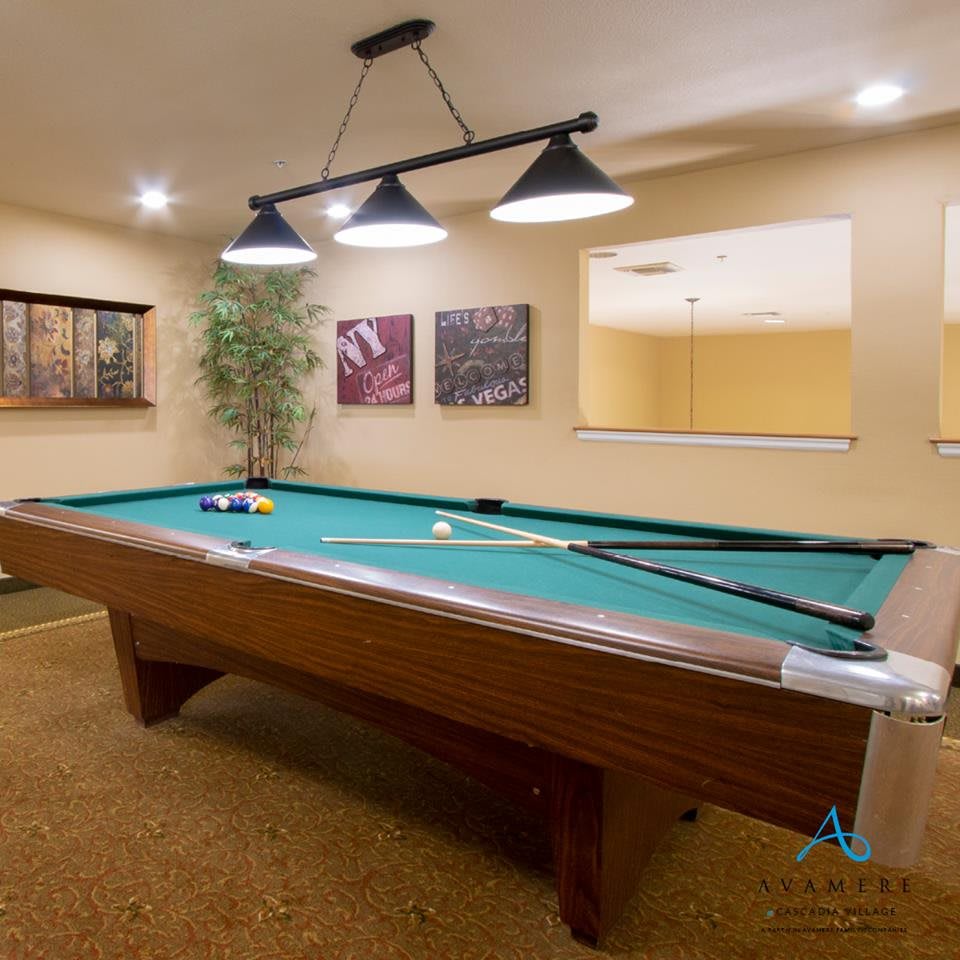 A well-designed game room with a pool table and stylish lighting.