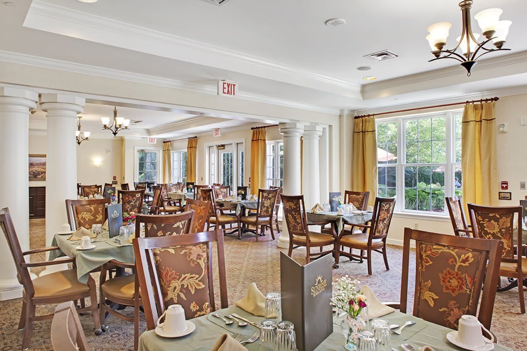 A spacious dining room with neatly arranged tables and chairs.